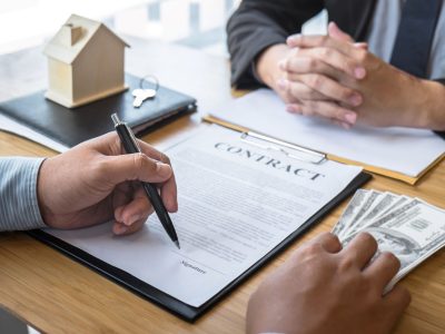 estate-agent-are-presenting-home-loan-giving-house-keys-customer-after-signing-contract