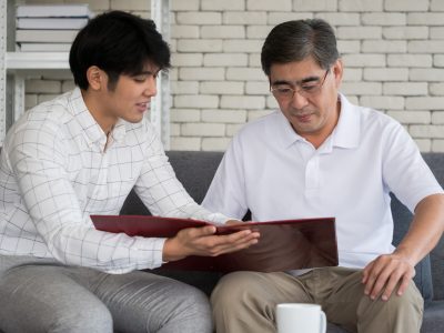 Young man agent recommending life insurance to senior man.